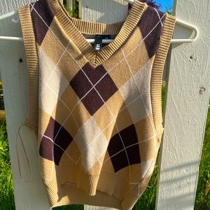 Garage sweater vest with shades of brown, cropped with vee neck line.
